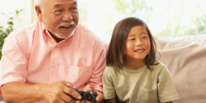 Grandpa gaming with child