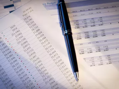 Financial sheets and pen