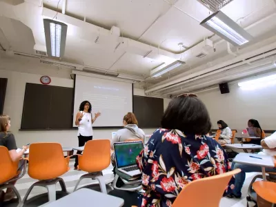 Teacher in front of classroom filled with students