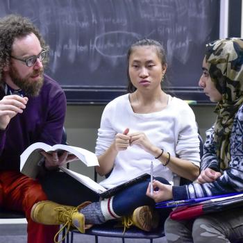 Students in a discussion with faculty