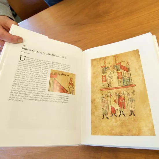 A book open to a page of medieval art