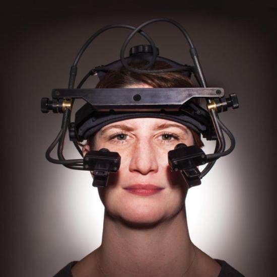 Female figure from the shoulders up, wearing a EEG monitor