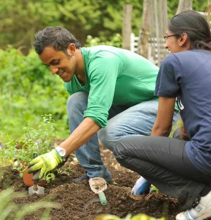 student planting in a garden 