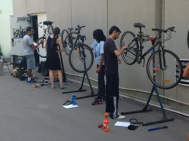 Volunteers outside the BikeShare office repairing bikes