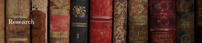 Image for Research page, of books lined up.
