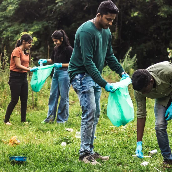 Students collecting garbage in a park