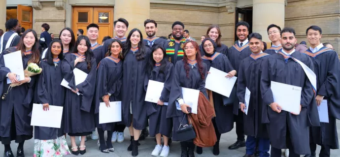 Group of MMI graduates at convocation in black gowns