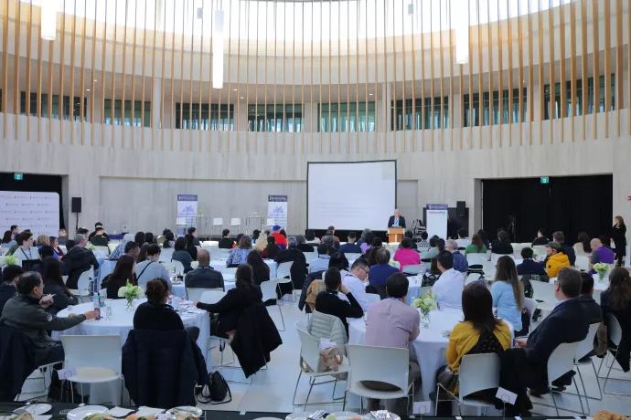 conference attendees in a large round room