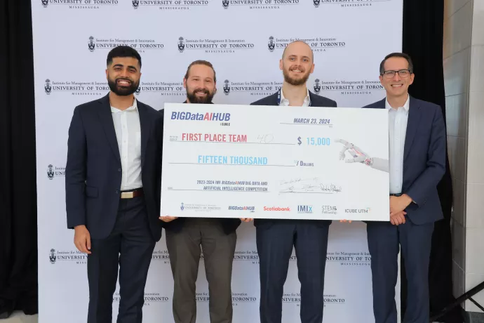 group of artificial intelligence competition winners with oversized cheque