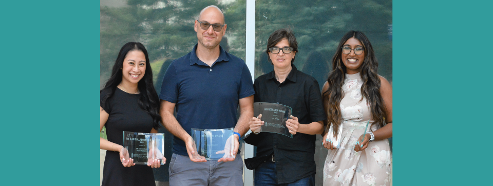 Four MUI members (staff, two faculty, student) holding their IMI Awards