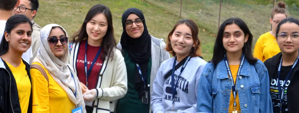 Group of students smiling, outdoors.