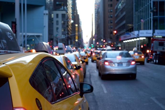 Blurred image of traffic on a busy city street. Image from Pixabay.