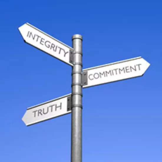Image of signpost with words integrity, truth and commitment