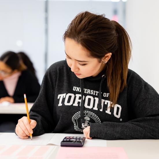 Student wearing a U of T sweater is writing an exam