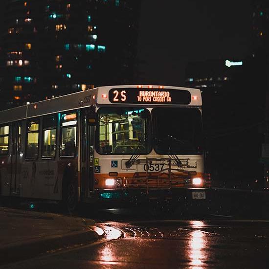 Mississauga bus on the street on a rainy night