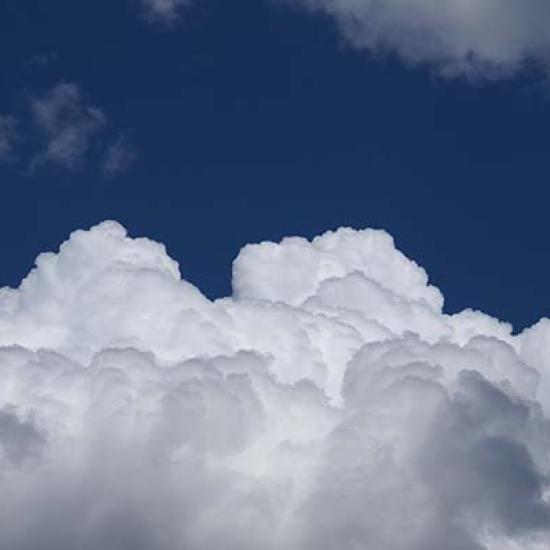 Fluffy white clouds against a blue sky. Image by Rafael Garcin on Unsplash