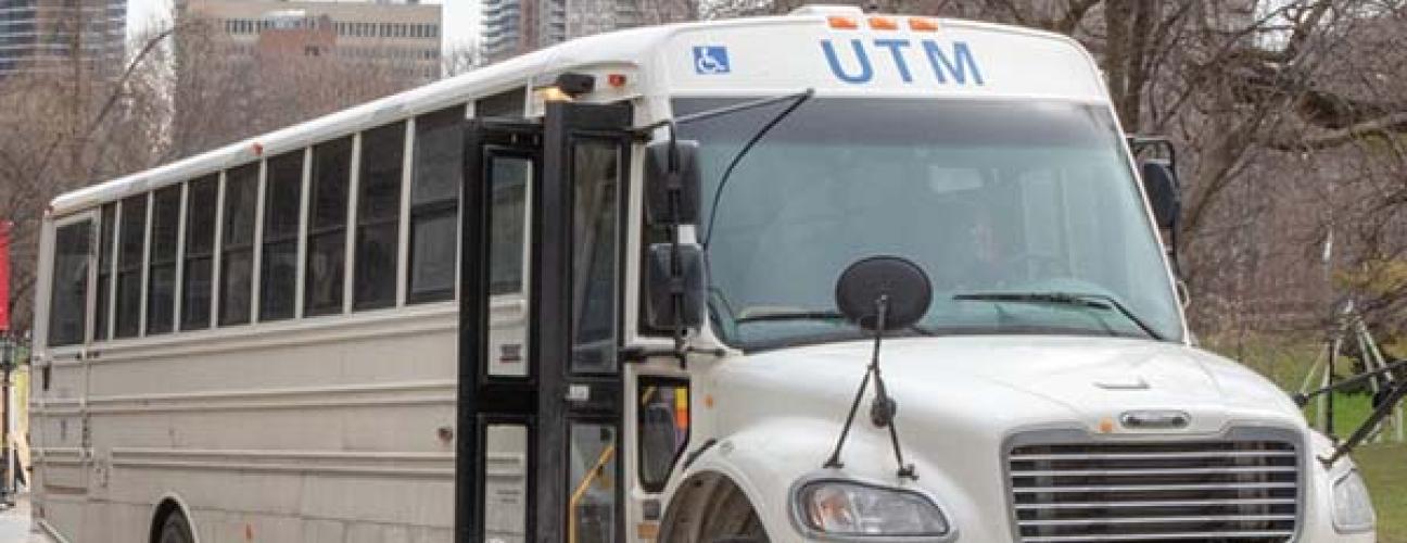 UTM shuttle bus on a cloudy day