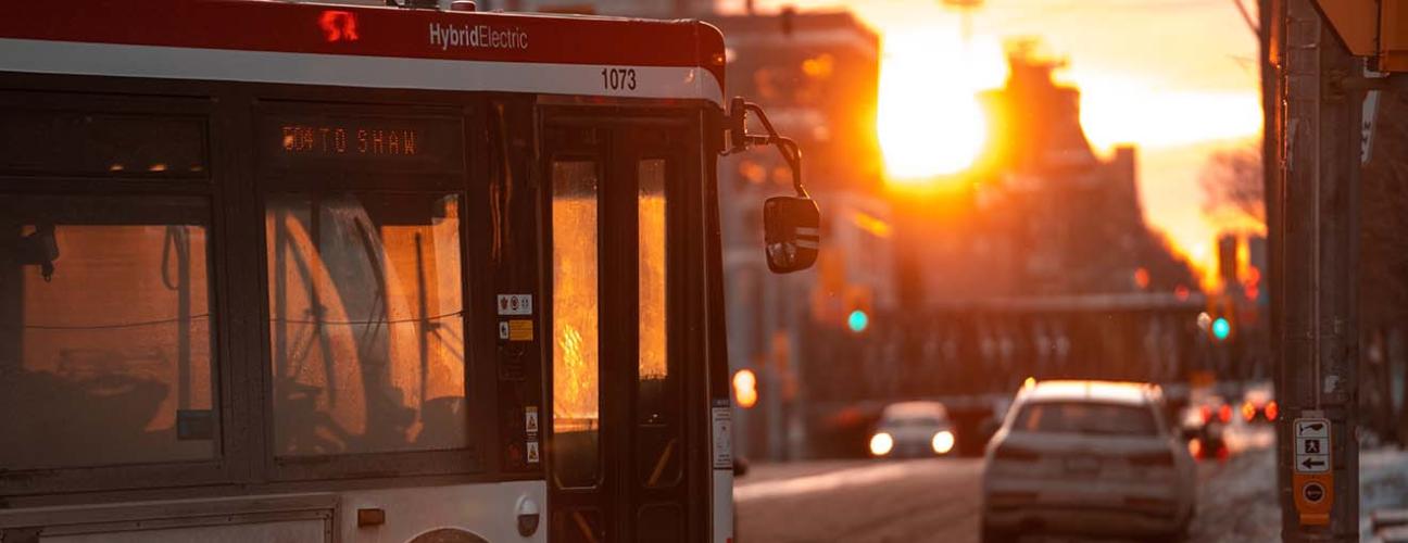 TTC bus turning on a downtown Toronto street at sunset. Photo by Brian Jones on Unsplash