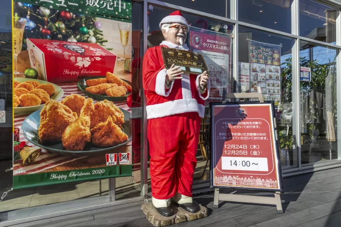 A statue of KFC mascot Colonel Sanders dressed as Santa Claus on display in front of the restaurant in Japan.