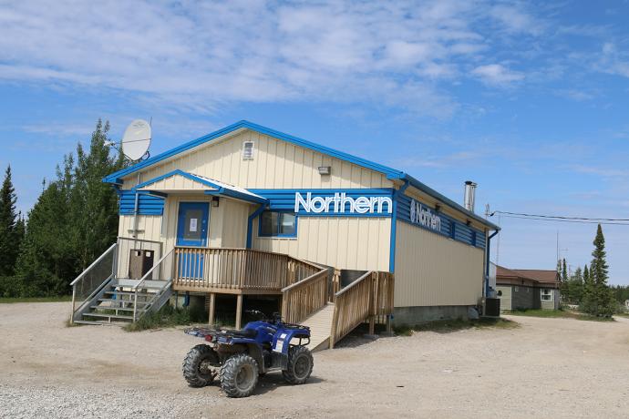 A small building with a ramp at the front and an ATV four-wheeler parked in front. A sign on the building reads Northern