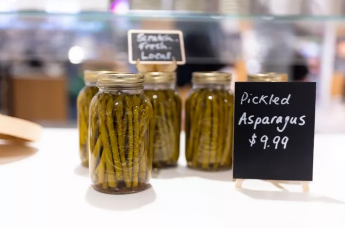 Pickled asparagus in a glass jar.