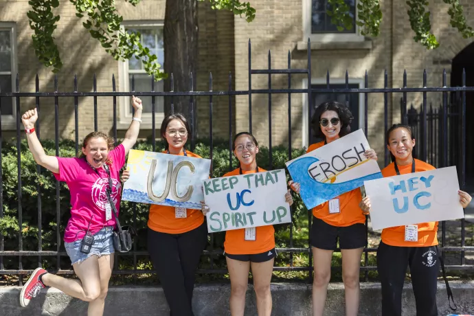 Volunteers hold up signs during Move-In Day.
