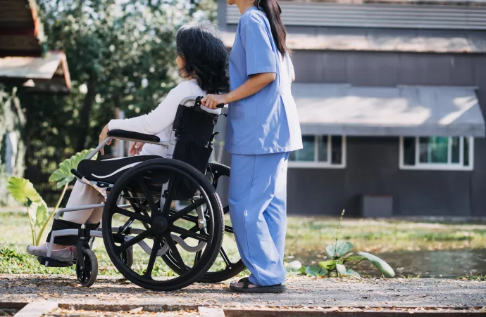 homecare worker helps a woman in a wheelchair