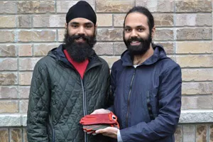 Ameek Brar (right) and his brother Ameer display their startup's glove designs