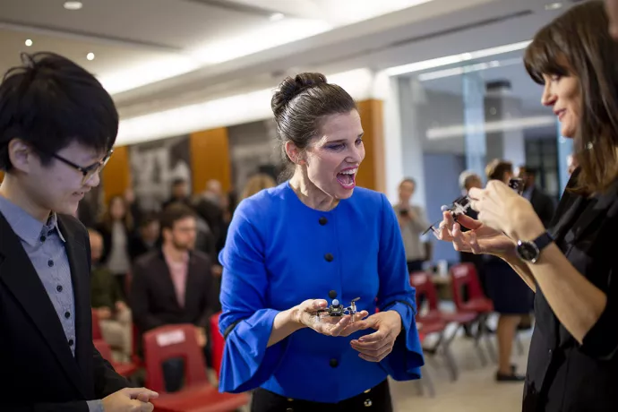 Kirsty Duncan, the federal science minister, talks to U of T Assistant Professor Angela Schoellig (right) and one of her students (left) about the self-flying drones created in Schoellig's lab