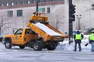 Workers manually spreading salt from a salt truck in Milwaukee, Wisconsin.