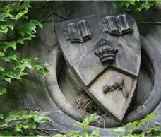 Stone crest surrounded by green ivy