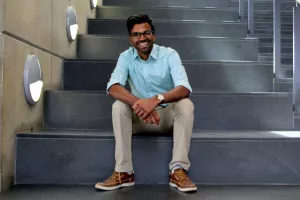 Daniel Jayasinghe sits on the stairs