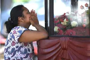 A woman prays at St. Sebastian's Church in Negombo on April 22, a day after the building was hit as part of a series of bomb blasts targeting churches and luxury hotels in Sri Lanka