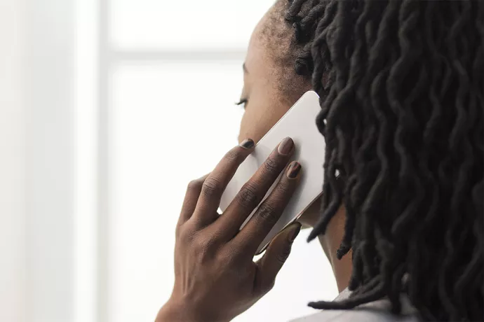 Woman facing away from camera on cell phone