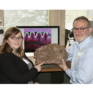 Kirstin Brink and Robert Reisz holding a fossil Dimetrodon skull