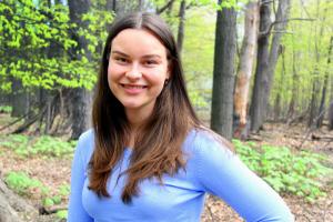 Image of Laura Krajewski standing in the woods and smiling