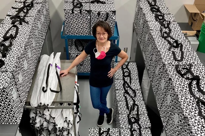 Lisa Cheung standing in a room surrounded by black and white boxes