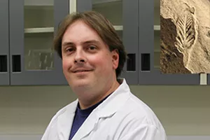 Professor Marc Laflamme in his laboratory with fossil of Ediacara