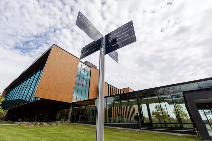 Photo of a wayfinding sign in front of the UTM Library.