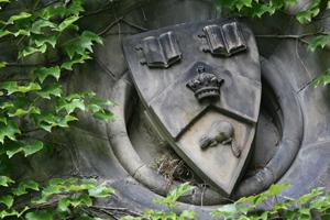 Stone crest on an ivy-covered wall