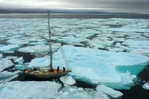 Sailboat in a sea of arctic ice