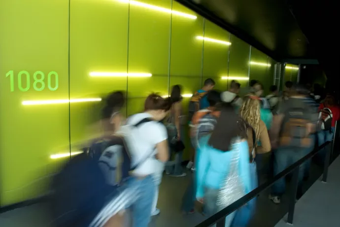students walking by green wall at CCT