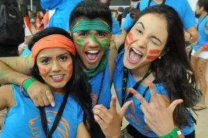 three university students with facepaint smling