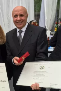 Man smiling and holding a certificate