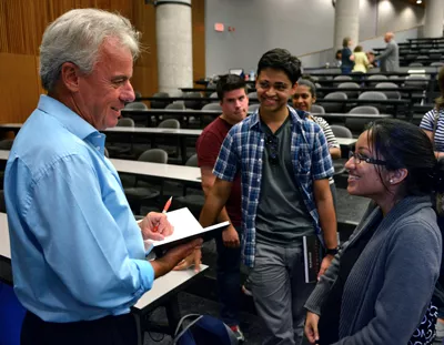 Bob McDonald speaks to student at lecture