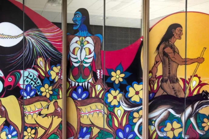 Colourful mural on glass panels that show stylized fish, bears, two humanoids and a wolf.