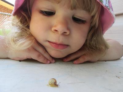 young girl watching snail