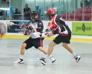 Two athletes playing lacrosse