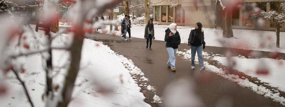 Students walking on UTM campus, surrounded by snow