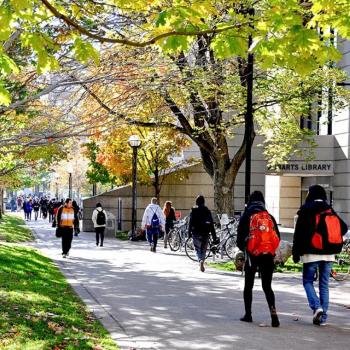 Students walking along a walkway on the U of T campus